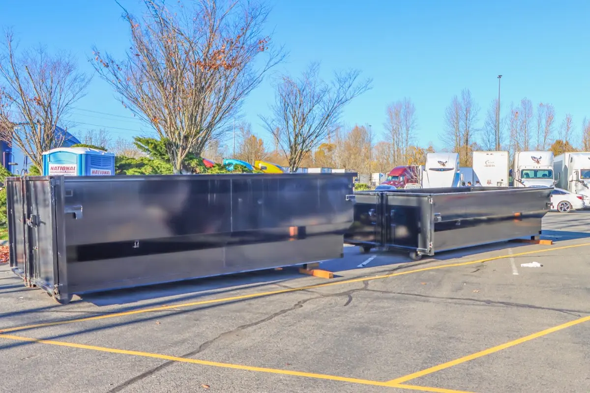 Professional dumpster rental service with roll-off container on residential driveway in Giddings